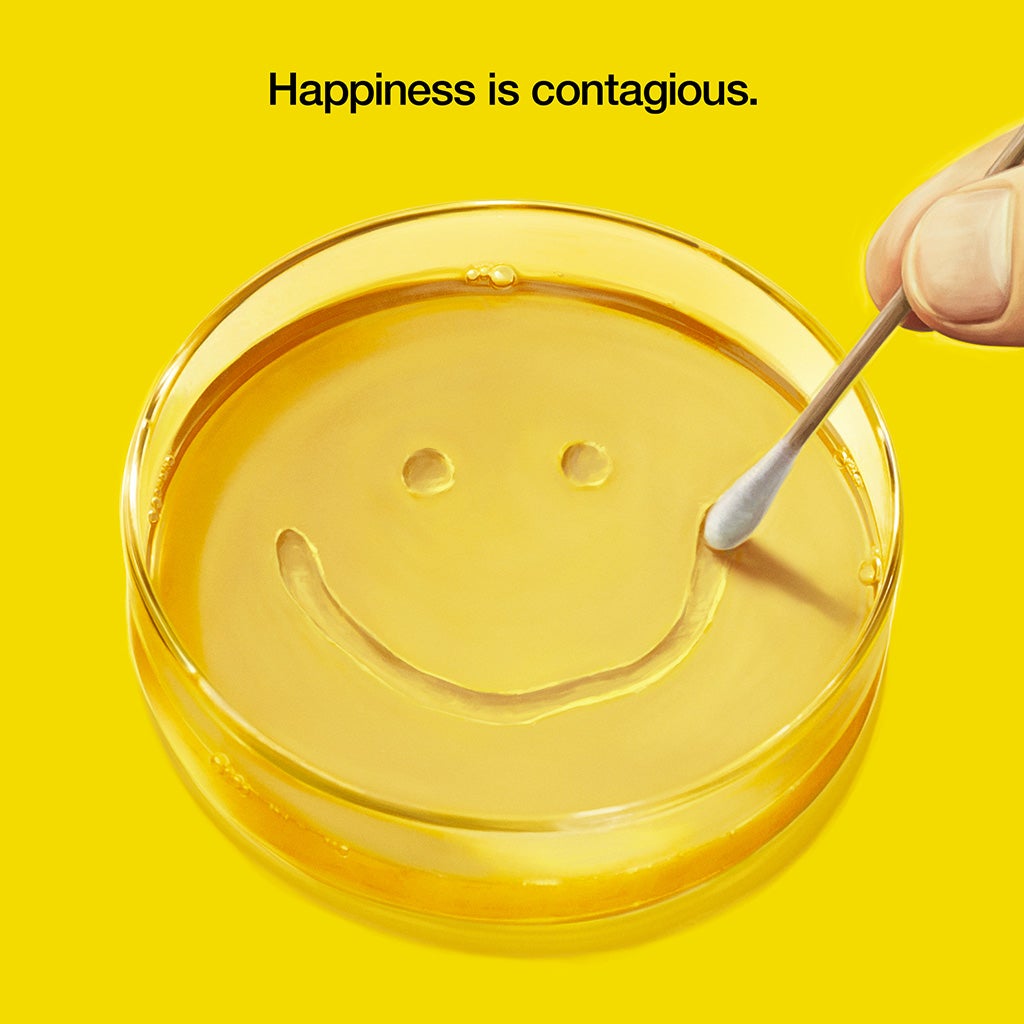 Yellow Pluribus promotional image with a smile drawn in a petri dish